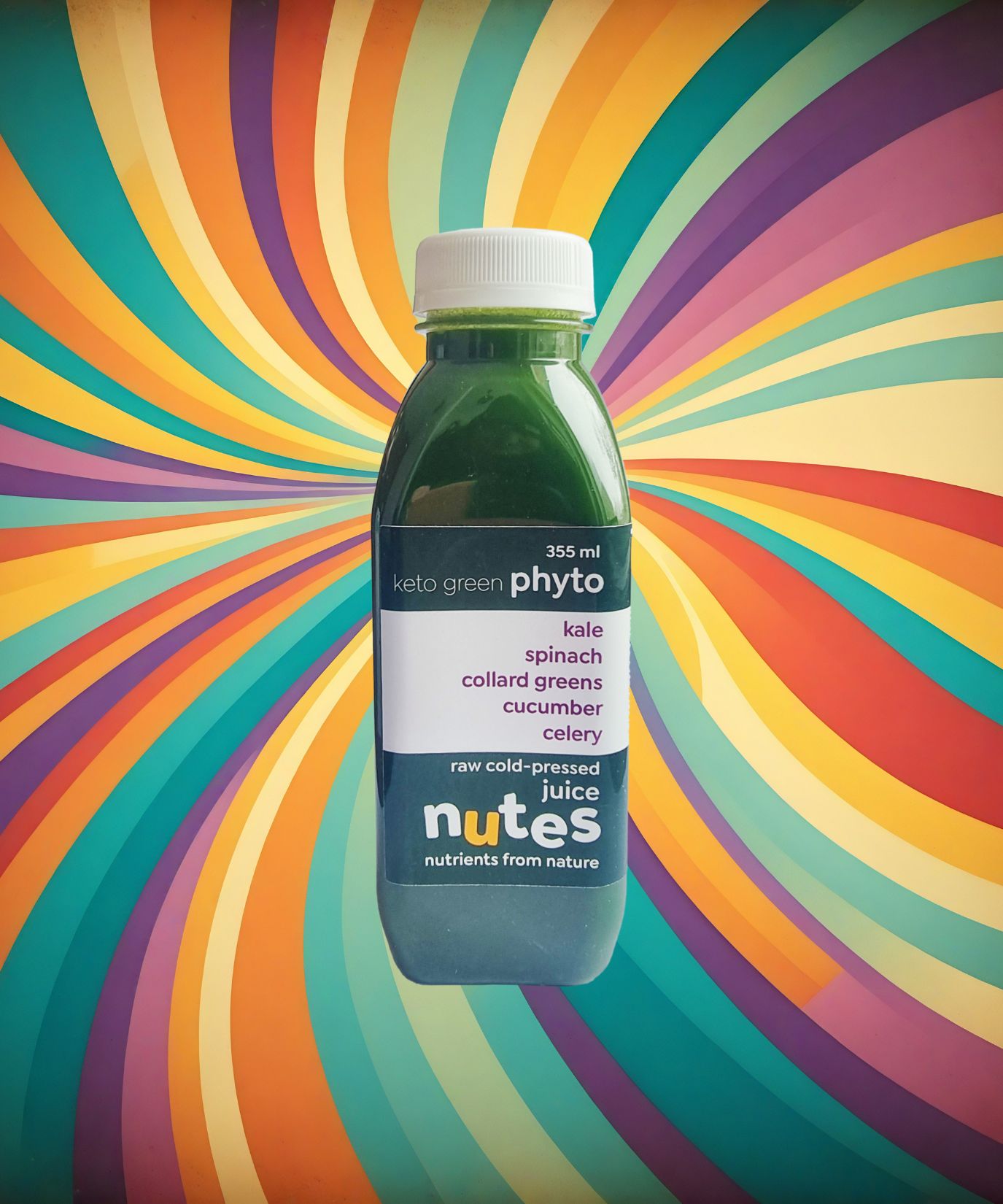 Nutes superfoods keto green flavoured cold-pressed juice bottle with high-vibe background