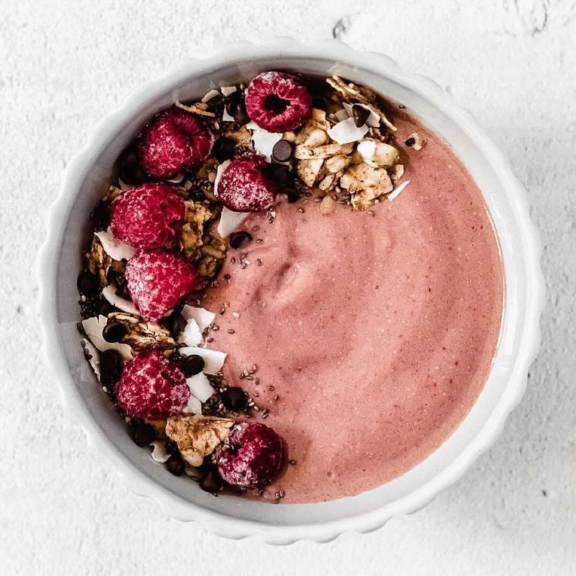 Nutes superfood smoothie bowl with raspberries, granola and coconut