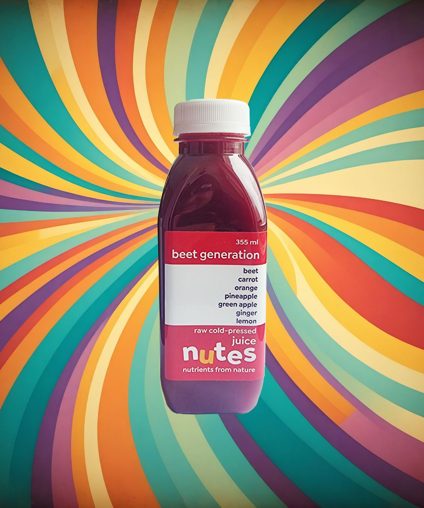 Nutes superfoods beet generation flavoured cold-pressed juice bottle with high-vibe background
